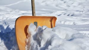 Yellow snow shovel used by a snow removal company