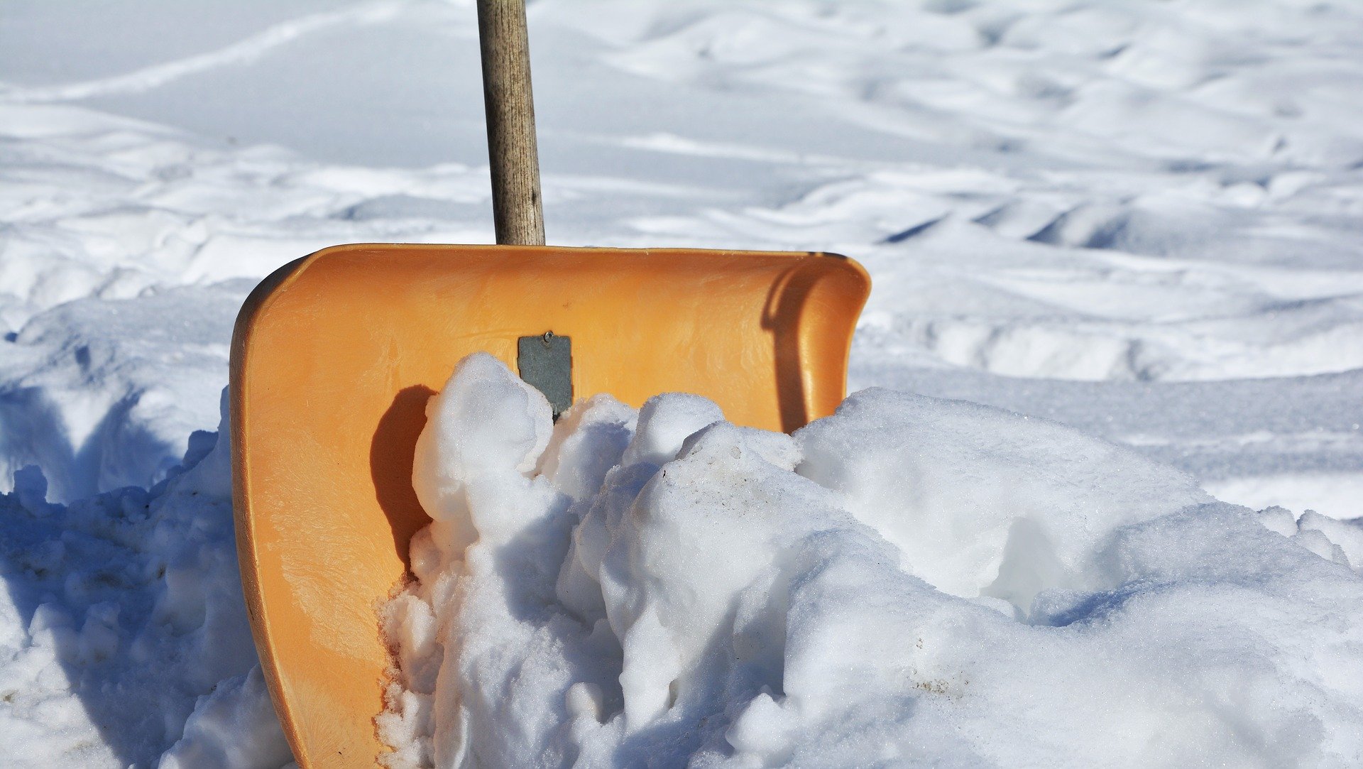 Yellow snow shovel used by a snow removal company