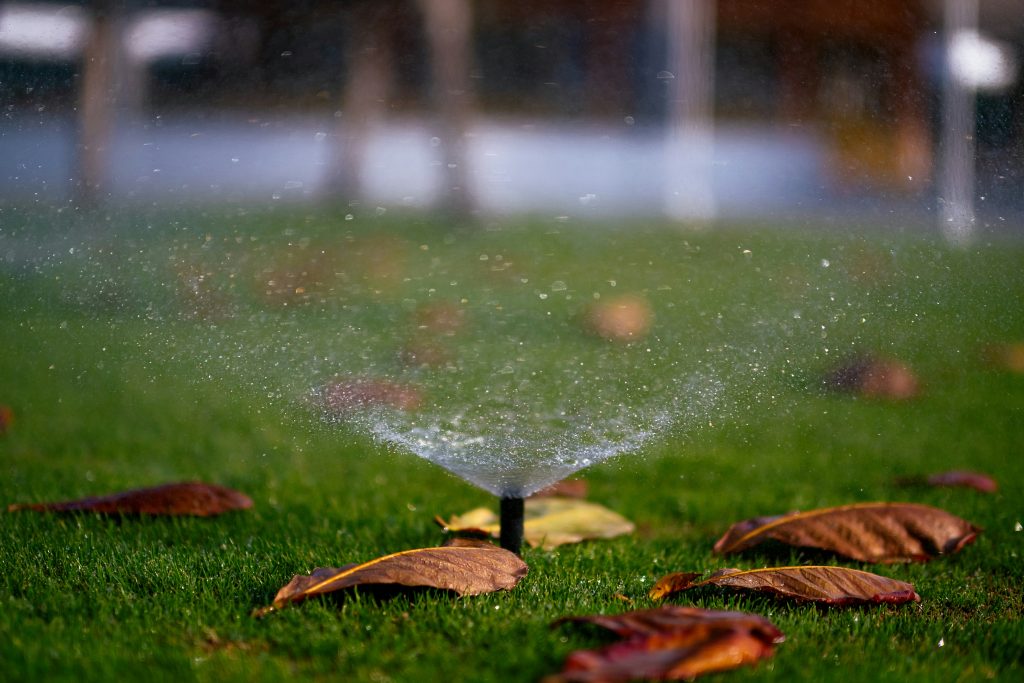Sprinkler system spraying water across a lush lawn in St. Louis, ensuring efficient irrigation and lawn care.